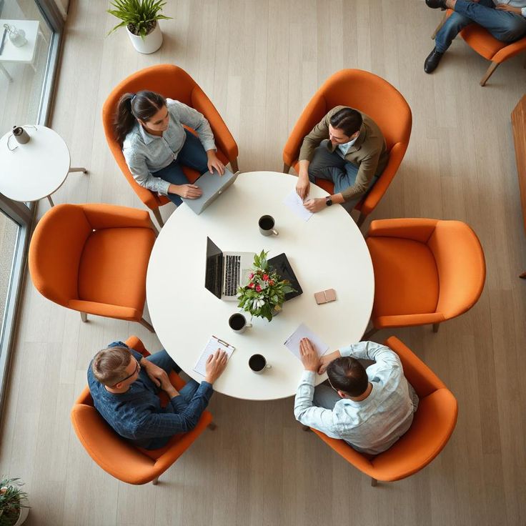 Facilitator leading a workplace energy workshop with engaged team members seated in a circle